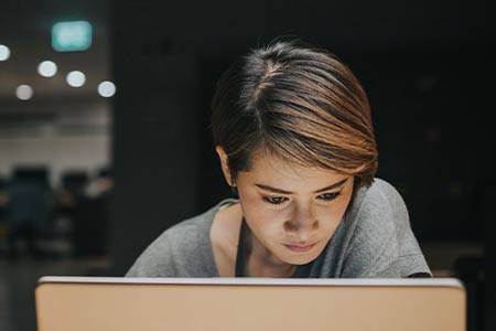 woman focusing on computer